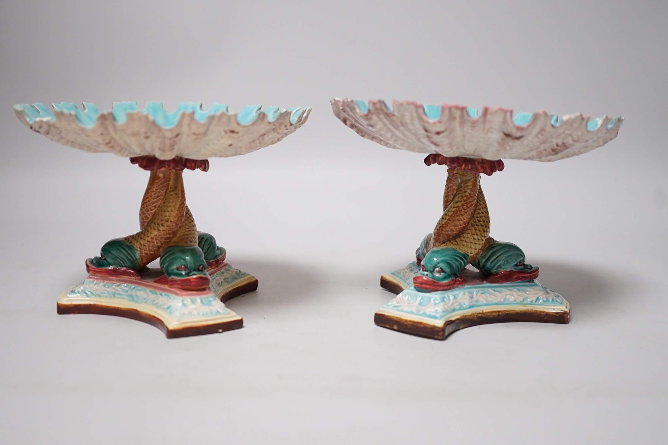A pair of late 19th century Royal Worcester majolica dolphin comports, 10cm tall
